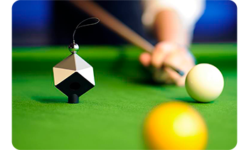 image of datacolor spyder cube sitting on green felt snooker table with playing about to hit the cue ball