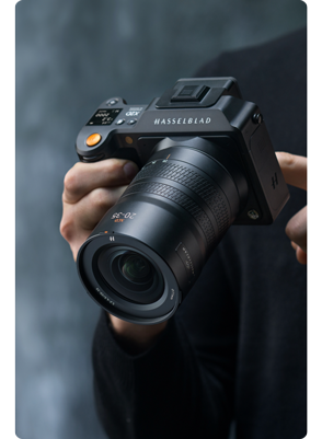 person holding hasselblad x2d with xcd 20-35E lens
