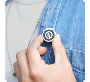 image of person holding Lark M2 on collar with magnetic mount