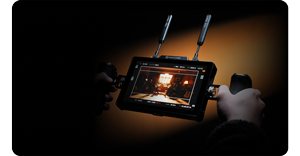 photograph of person holding hollyland pyro 7 against orange background