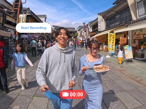 couple walking along asian street with Insta360 X5 activating voice