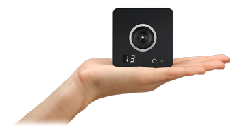 person holding SlimX 13 mo-cap camera in open hand