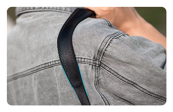 somone holding the camera camera strap over their shoulder