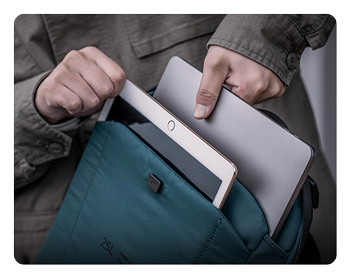 someone pulling a laptop out of the pgytech onemo 2 camera backpack