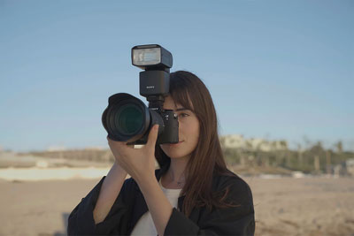 someone taking a photo using the sony a9 iii