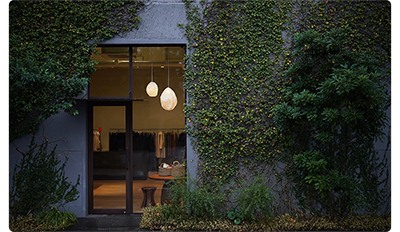 Sony FE 50mm F1.2 G Master Lens sample image of modern architecture home with ceiling lights and ivy growing on the outside