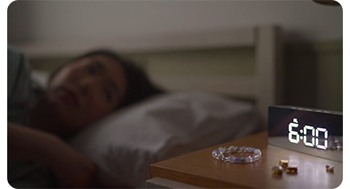 Close up image of digital clock on bedside table