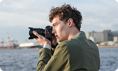 someone taking a photo using the sony e mount lens