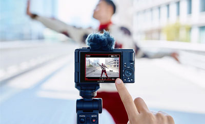 someone using the sony zv 1 ii compact camera