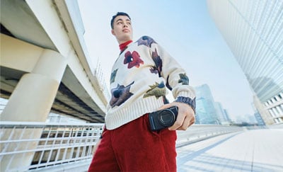 someone holding the sony zv 1 ii compact camera