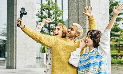 someone taking a selfie with the sony zv 1 ii compact camera