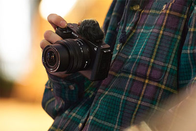someone taking a photo using the sony zv e1 vlog camera