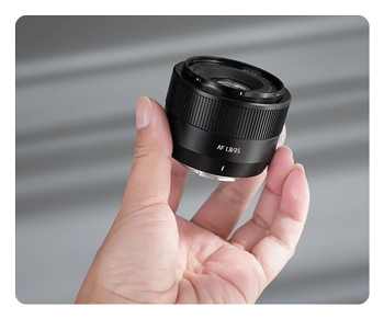 someone holding the AF 35mm F1.8 Mark II lens