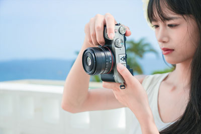 someone taking a photo using the ttartisan af lens