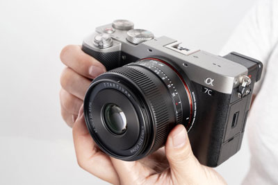 close up of a camera with the ttartisan af lens attached